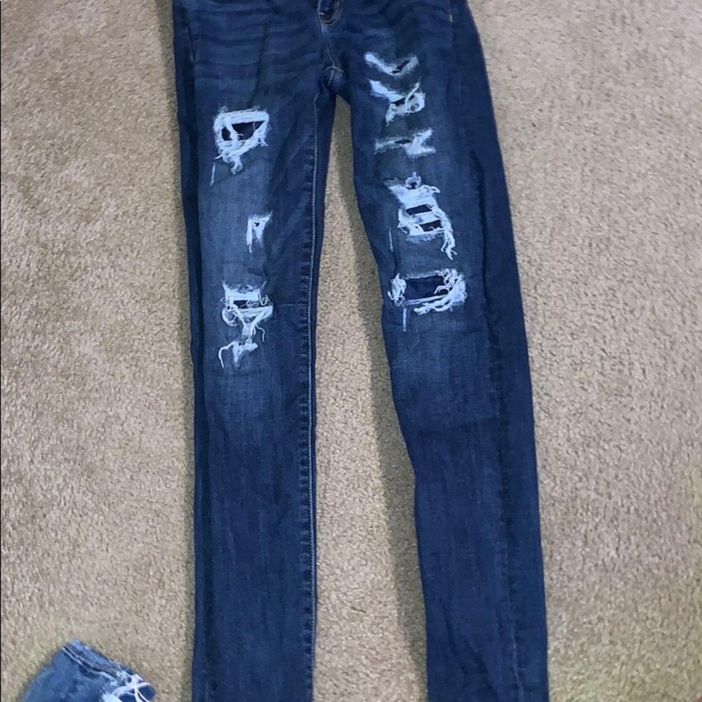 dark washed ripped jeans, covered rips